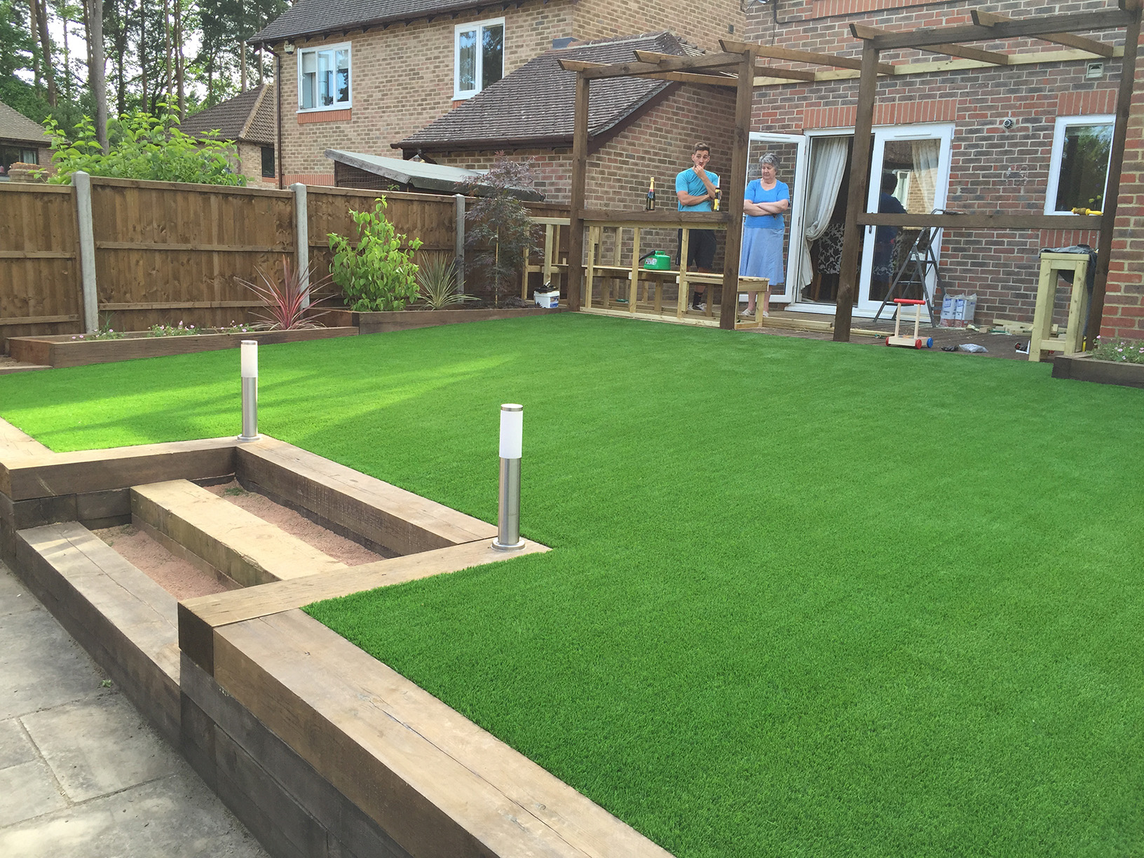 Sleepered retaining wall and steps